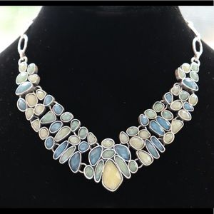 REVERSIBLE NECKLACE IS SILVER METAL ON ONE SIDE WITH INLAID COLORED STONES